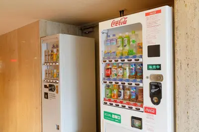 a vending machine with bottles of soda and drinks at the b sangenjaya in Tokyo
