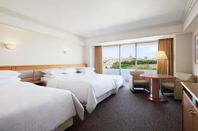 a hotel room with two beds and a table at Sheraton Grande Tokyo Bay Hotel in Urayasu
