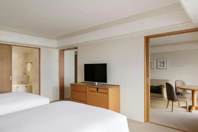 a hotel room with a bed and a flat screen tv at Sheraton Grande Tokyo Bay Hotel in Urayasu