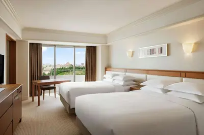 a hotel room with two beds and a television at Sheraton Grande Tokyo Bay Hotel in Urayasu