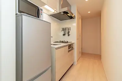 a kitchen with a refrigerator and a stove at Oakwood Apartments Minami Azabu Tokyo in Tokyo