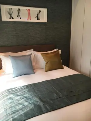 a bedroom with a large bed with pillows at Oakwood Apartments Minami Azabu Tokyo in Tokyo