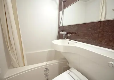 a white bathroom with a sink and a toilet at Hotel Trend Tobu Asakusa-Eki Kita in Tokyo