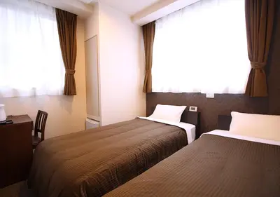 a hotel room with two beds and a window at Hotel Trend Tobu Asakusa-Eki Kita in Tokyo