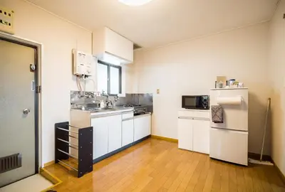 a kitchen with white cabinets and a sink and a refrigerator at Murata COPO 305 / Vacation STAY 2893 in Tokyo