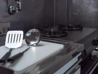 a kitchen counter with a stove with a spoon on it at Murata COPO 305 / Vacation STAY 2893 in Tokyo