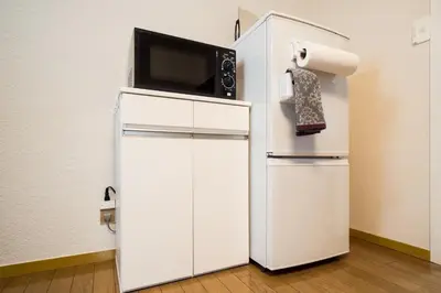 a white refrigerator with a microwave on top of it at Murata COPO 305 / Vacation STAY 2893 in Tokyo