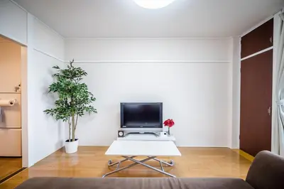 a living room with a tv and a table at Murata COPO 305 / Vacation STAY 2893 in Tokyo