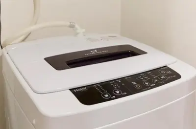 a white microwave sitting on top of a washing machine at Dwell Urban 7A in Tokyo