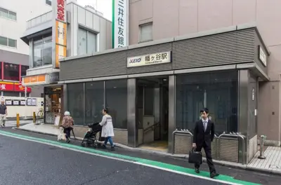 a group of people walking in front of a building at Dwell Urban 7A in Tokyo