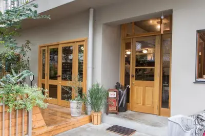 a front door of a house with wooden doors at Dwell Urban 7A in Tokyo
