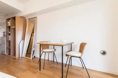 a table and two chairs in a room at Dwell Urban 7B in Tokyo