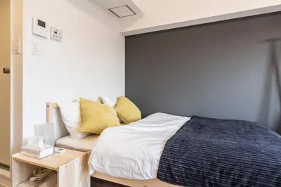 a bedroom with a bed and a couch at Dwell Urban 6D in Tokyo