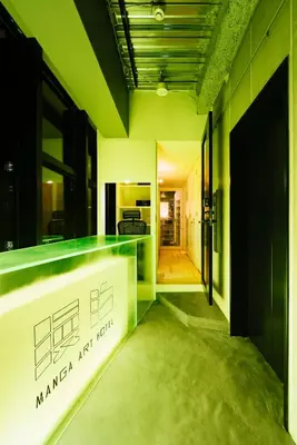 a kitchen with a green counter in a room at MANGA ART HOTEL, TOKYO in Tokyo