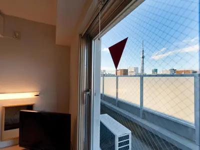 a room with a window with a view of the city at Super Hotel Tokyo Kameido in Tokyo