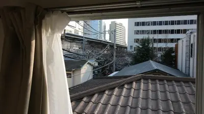 a window with a view of a roof at COCO Nakameguro301 in Tokyo