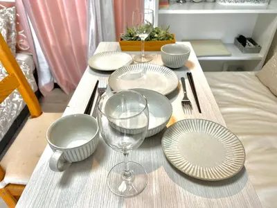 a wooden table with plates and wine glasses on it at COCO Nakameguro302 in Tokyo