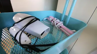 a plastic container with a hair dryer and tooth brushes at COCO Nakameguro302 in Tokyo