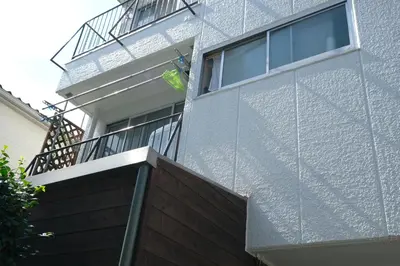 a man standing on the balcony of a building at COCO Nakameguro302 in Tokyo