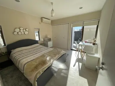 a bedroom with a bed and a desk and a window at near shibuya quiet residential area in Tokyo