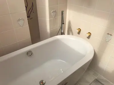 a white bath tub in a bathroom at near shibuya quiet residential area in Tokyo
