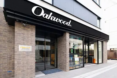 a store with a sign on the front of a building at Oakwood Apartments Nishi-Shinjuku Tokyo in Tokyo