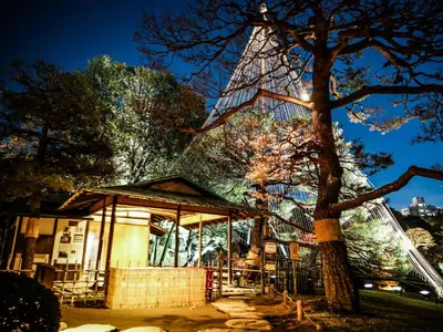 a building with a tree in front of it at APA Hotel Komagome Ekimae in Tokyo