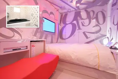 a room with a bedroom with a bed and a tv at HOTEL DCUBE in Tokyo