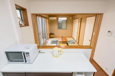 a small kitchen with a microwave and a microwave at Yotsuya 110 in Tokyo