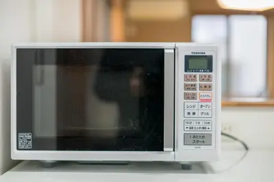 a microwave oven sitting on top of a table at Yotsuya 110 in Tokyo