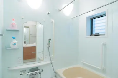 a bathroom with a tub and a sink and a mirror at Yotsuya 110 in Tokyo