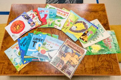 a group of books on a wooden table at Yotsuya 110 in Tokyo