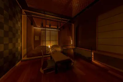 a room with a table and a bed and a window at cyashitsu ryokan asakusa in Tokyo