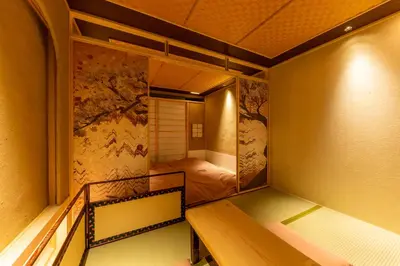 a small room with two bunk beds and a bedroom at cyashitsu ryokan asakusa in Tokyo