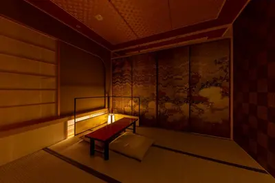 a room with a bench and a painting on the wall at cyashitsu ryokan asakusa in Tokyo