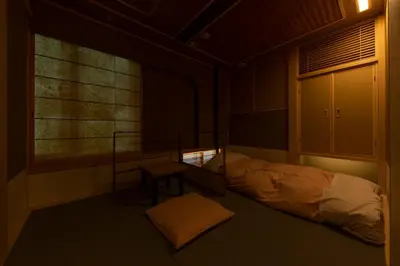 a room with a bed and a table and a window at cyashitsu ryokan asakusa in Tokyo