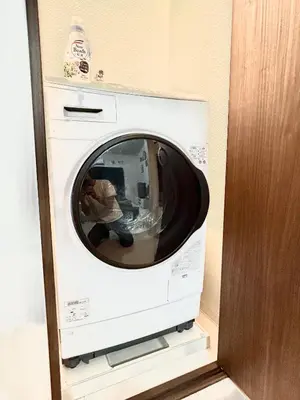 a white washing machine sitting in a room at Gracias Arakawa - Great Access to UENO & ASAKUSA area in Tokyo