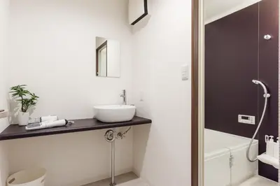 a bathroom with a sink and a toilet and a shower at Gracias Arakawa - Great Access to UENO & ASAKUSA area in Tokyo