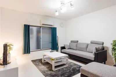 a living room with a couch and a table at Gracias Arakawa - Great Access to UENO & ASAKUSA area in Tokyo