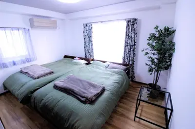 a bedroom with a bed with two pillows and a window at Central Field 5-6F in Tokyo