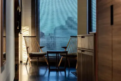 two chairs and a table in front of a window at La'gent Hotel Shinjuku Kabukicho in Tokyo