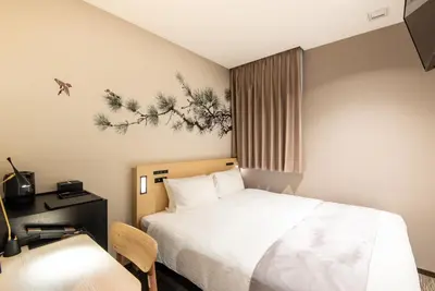 a hotel room with a bed and a desk and a chair at La'gent Hotel Shinjuku Kabukicho in Tokyo