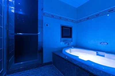 a blue bathroom with a tub and a shower at HOTEL D-WAVE Shinjuku\uff08Adult Only) in Tokyo