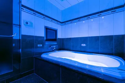 a bathroom with a tub and a glass shower at HOTEL D-WAVE Shinjuku\uff08Adult Only) in Tokyo