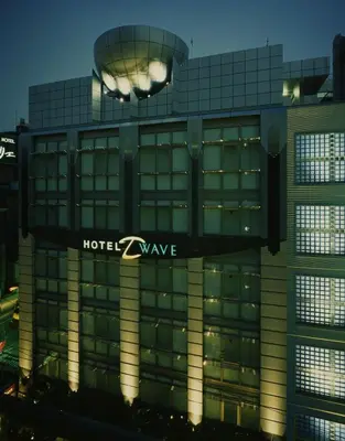 a building with a hotel wave sign on it at HOTEL D-WAVE Shinjuku\uff08Adult Only) in Tokyo
