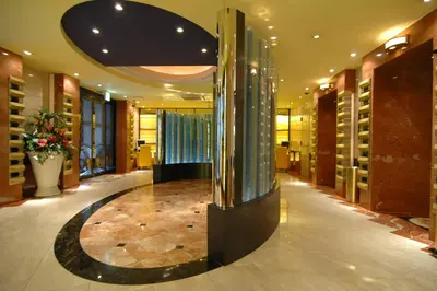 a lobby with a circular hallway with a vase of flowers at HOTEL D-WAVE Shinjuku\uff08Adult Only) in Tokyo