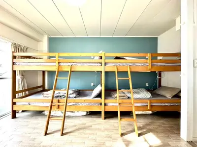 a room with three bunk beds in it at Jujo Stay Sanyo Mansion in Tokyo