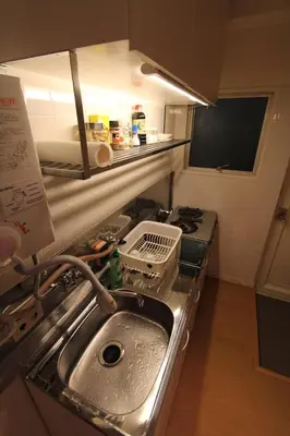 a kitchen with a sink and a stove at Jujo Stay Sanyo Mansion in Tokyo