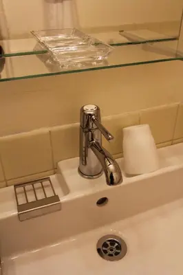a sink with a faucet in a bathroom at Jujo Stay Sanyo Mansion in Tokyo