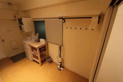a small room with a sliding door in a room at Jujo Stay Sanyo Mansion in Tokyo